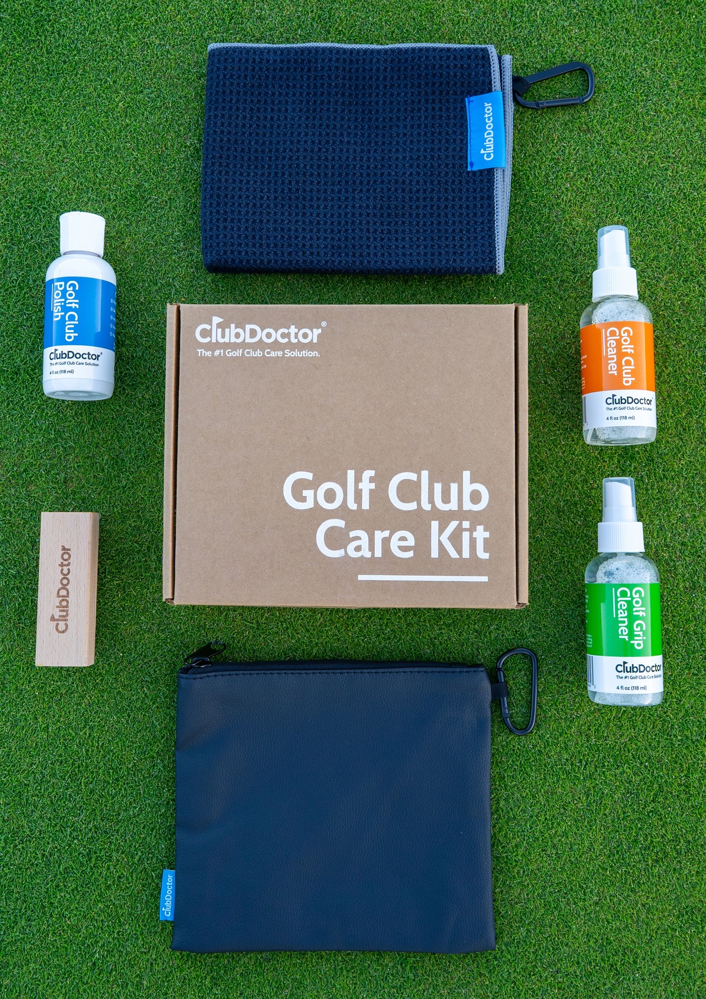 The six-piece Club Doctor Golf Club Care Kit arranged on turf