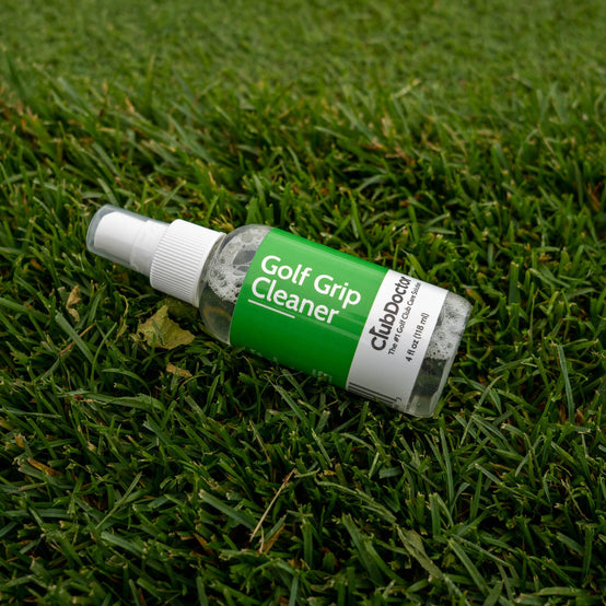 club doctor golf grip cleaner bottle laying in the grass